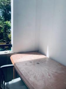 a table in a room with a window at Center Point Villa Unawatuna in Unawatuna