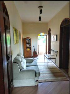 a living room with a couch and a chair at Casa Colonial in São Lourenço