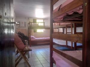 a room with several bunk beds in a house at Hostel Porto Vip in Porto De Galinhas