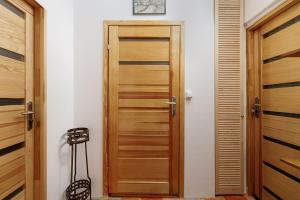 a hallway with a wooden door and a stool at Stare Miasto Krupnicza in Wrocław