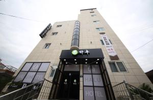 a tall building with a sign on the front of it at HARU Hotel in Changwon