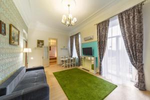 a living room with a couch and a green rug at Apartment on Sumskaya 46 "Family" in Kharkiv