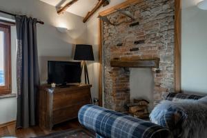 a living room with a couch and a brick wall at Number 10 Locanda B&B in Belvedere Langhe