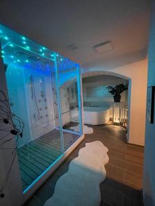 a large bathroom with a tub and a large aquarium at Escape Private SPA II in Bad Zurzach