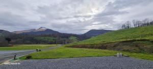 a road with a mountain in the distance at Au Nid de Caroline gîte 4 étoiles in Arette