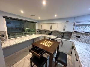 a kitchen with a wooden table and a sink at Mara Boutique Apartments 1 in Oldbury