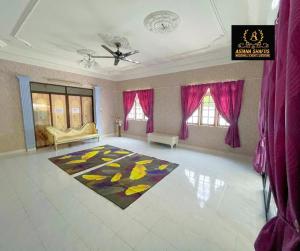 a large living room with pink curtains and a rug at ASTANA SHAFIIS in Malacca