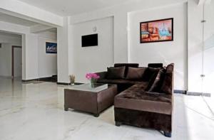 a living room with a couch and a coffee table at Boutique Hotel vivaan suites in Noida