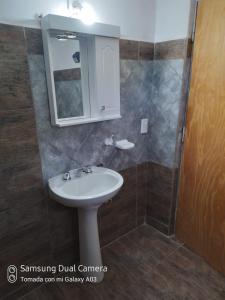 a bathroom with a sink and a mirror at Nancy's Residencias in Santa Rosa de Calamuchita