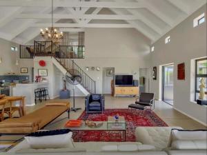 a living room with a couch and a table at Julu Guest House in Riebeek-Kasteel