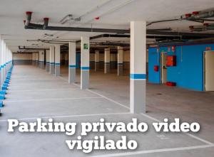 a large empty parking garage with blue and white columns at Apartamento Playa de Punta Candor in Rota