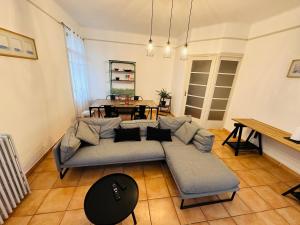 a living room with a couch and a table at Appartement T3 67m² in Perpignan