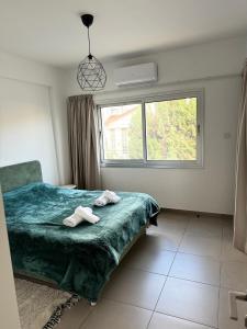 a bedroom with a bed with two towels on it at Anastasia 1 Bedroom Apartment in Limassol