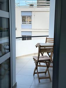 a chair and a table on a balcony at Anastasia 1 Bedroom Apartment in Limassol