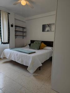 a bedroom with a bed and a ceiling fan at Fuengirola Central in Fuengirola