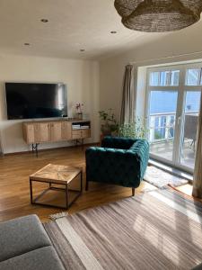a living room with a couch and a flat screen tv at Beach apartment in a peaceful neighbourhood in Jūrmala
