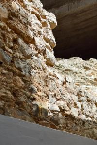 una pared de piedra junto a un túnel en un edificio en A Muralha en Tavira