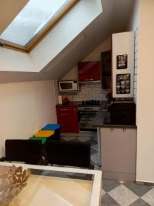 a kitchen with a skylight in a loft at Apartament Pod Bukami in Łaziska Górne