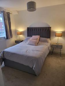 a bedroom with a large bed with two end tables at Moorgreen 