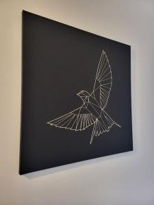 a drawing of a bird on a black canvas at Moorgreen 