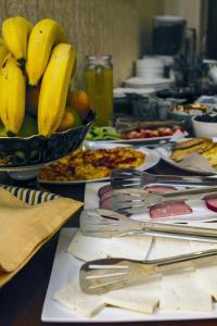 a table with a bowl of bananas and other food at Swan Hotel Baku in Baku