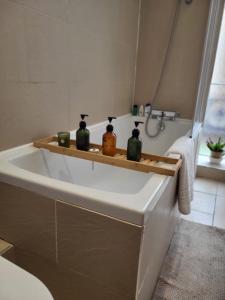 a bathroom with a bath tub with three candles on it at Imperial House "Serviced Apartments" in Margate