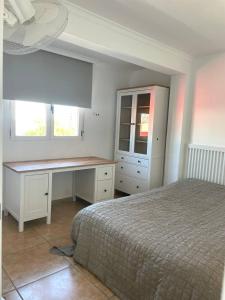 - une chambre avec un lit, un bureau et 2 fenêtres dans l'établissement Luis Vives, à Gandía