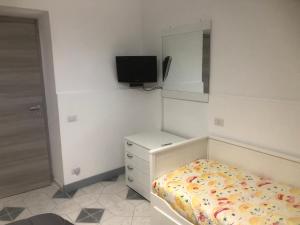 a bedroom with a bed and a dresser and a mirror at CASA DIANA in Lipari