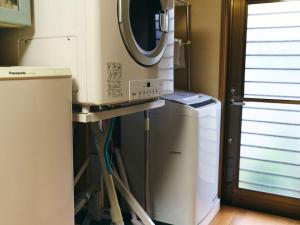 a kitchen with a refrigerator and a mirror at Folksy House / Vacation STAY 64171 in Izumo