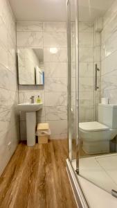 a bathroom with a shower and a sink and a toilet at The Fairhaven Hotel in Weymouth