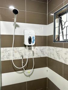 a shower in a bathroom with a hose at ~Big House UITM Hospital 11 Pax~ in Shah Alam