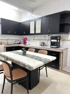 a kitchen with a large table and chairs in it at ~Big House UITM Hospital 11 Pax~ in Shah Alam