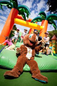 a brown teddy bear sitting on a playground ride at Camping Les Peupliers in La Flotte +67 photos