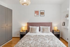 a bedroom with a large bed with two night stands at Herman Park View Cozy Apartment 1 in Bucharest