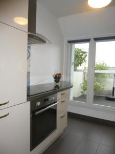a kitchen with a stove top oven next to a window at Appartement terrasse daumesnil in Paris