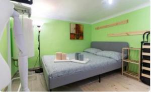 - une chambre dotée d'un lit avec un mur vert dans l'établissement Little Loft 14 appartamento vicino il centro di Bari, à Bari