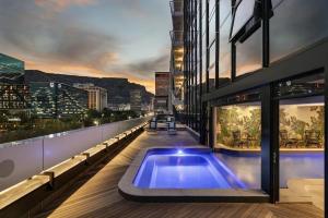 a swimming pool on the side of a building at Stylish City Living in Cape Town