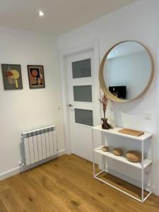 a mirror on a white shelf in a room at Plaza Tomás in Pamplona +24 photos