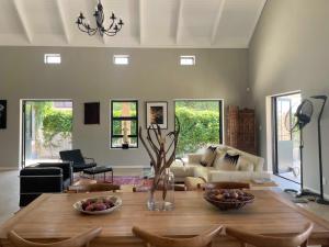 a living room with a table with fruit on it at Julu Guest House in Riebeek-Kasteel