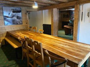 a large wooden table in a room with chairs at Joyeux Flocon - Spacieux chalet in Les Contamines-Montjoie