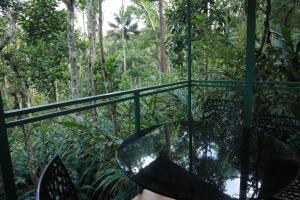 a glass table in the middle of a forest at SpiceBuds TreeHouse - Idukki in Ramakkalmedu
