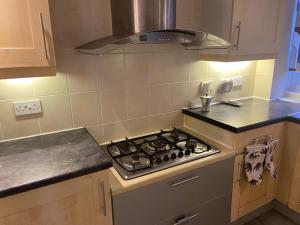 a kitchen with a stove top oven in a kitchen at TJ House in Sherborne Saint John