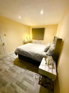 a bedroom with a bed and a table in it at TJ House in Sherborne Saint John