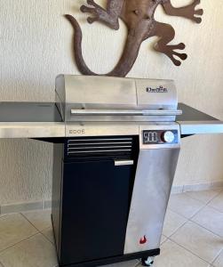 a counter top with a grill with a dinosaur on the wall at Sonoran Sea Resort BEACHFRONT Condo E203 in Puerto Peñasco