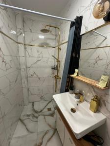 a white bathroom with a sink and a shower at Студио за нощувки Габрово in Gabrovo +12 photos