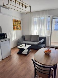 a living room with a couch and a table at Студио за нощувки Габрово in Gabrovo +12 photos