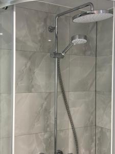 a shower with a glass door in a bathroom at Exquisite 2 Bedroom Fully Furnished Annex in Bradenham