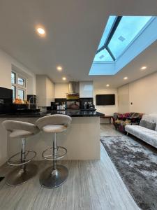 a kitchen and living room with a skylight at Exquisite 2 Bedroom Fully Furnished Annex in Bradenham