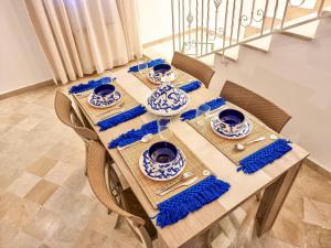 a table with blue and white dishes on it at Le Superbe - Sidi Bou Saïd in Dar Mimoun Bey