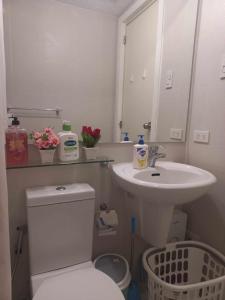 a bathroom with a white toilet and a sink at Azure Urban Resort Staycation By Owner Only in Manila